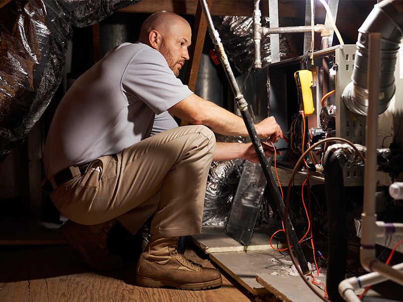Technician performing furnace maintenance